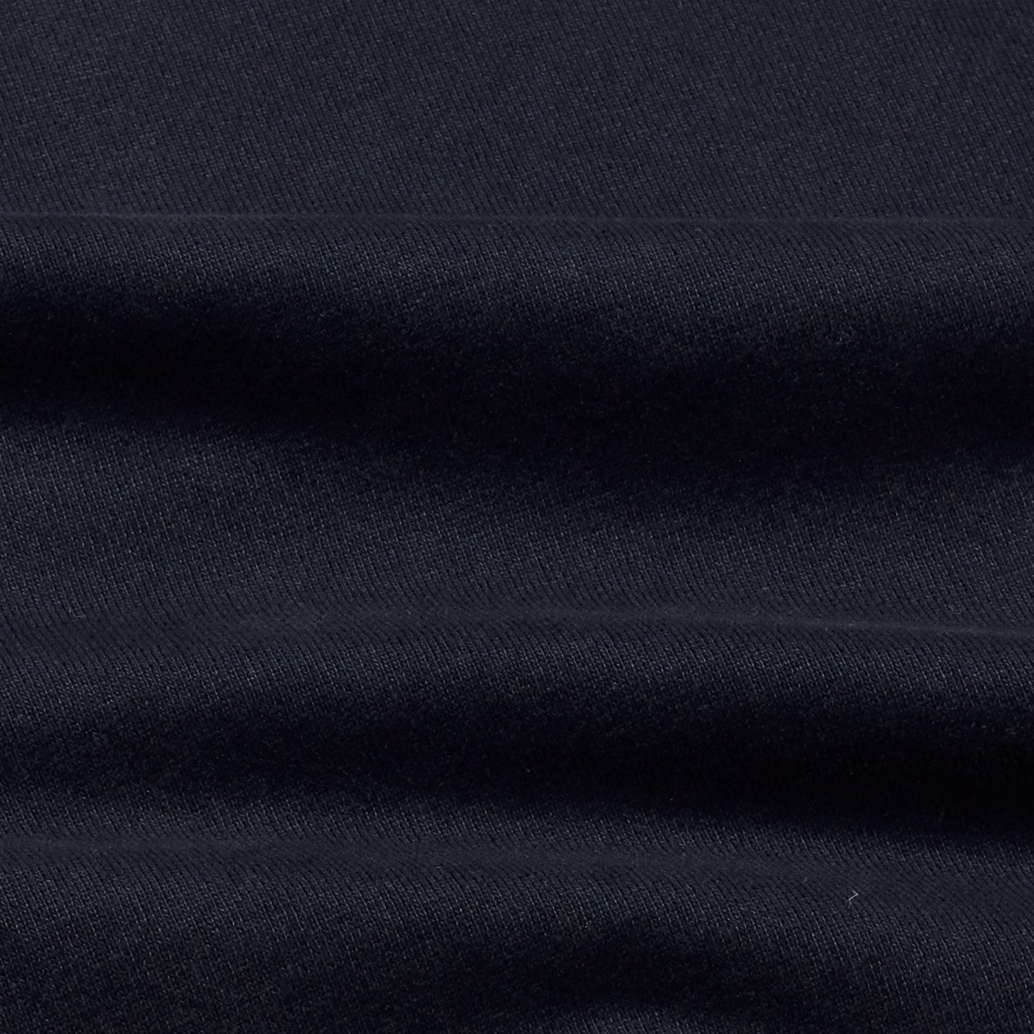 Close-up showing the texture of the navy t-shirt's fabric.