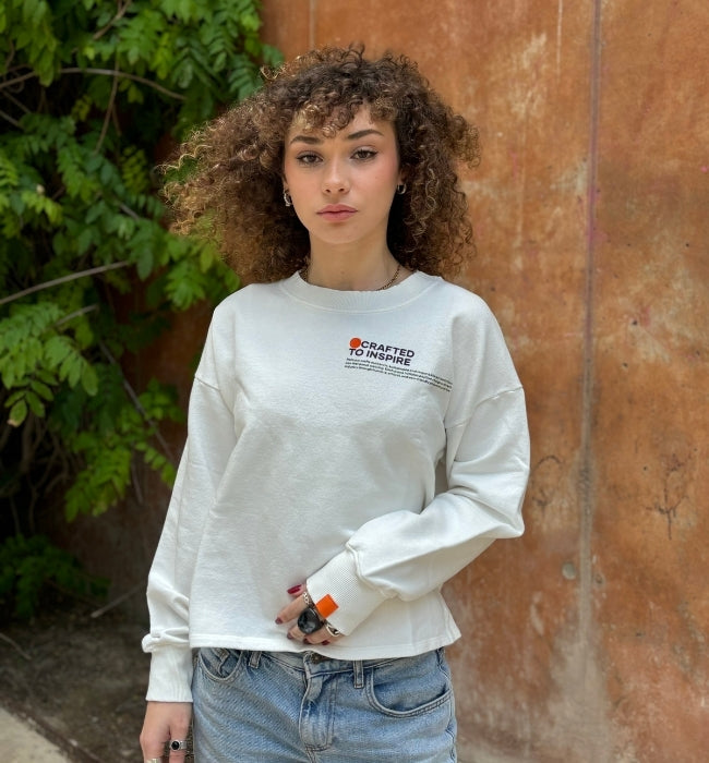 Model wearing oslo crafted collection crewneck with street background